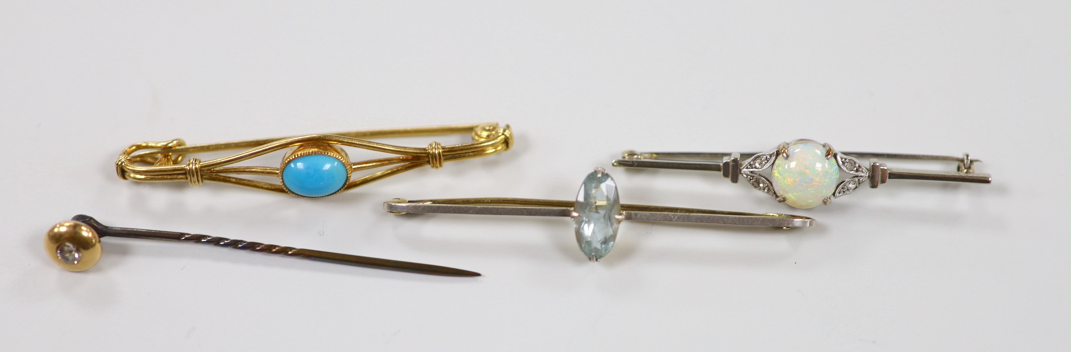 An Edwardian 15ct and single stone aquamarine set bar brooch, 58mm, gross 3.5 grams, two other bar brooches including a 9ct & plat, white opal and diamond chip and a diamond set stick pin, gross weight 11 grams.
